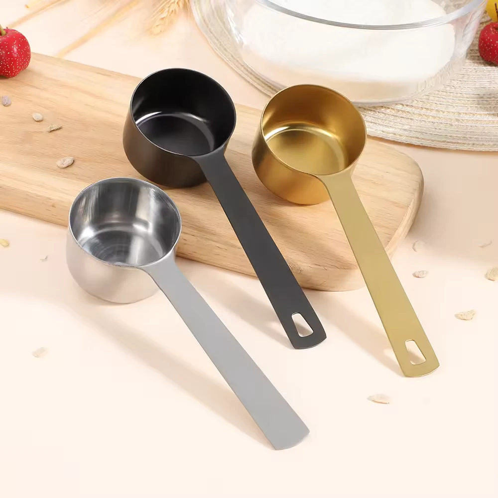 Black 60 millilitre stainless steel measuring scoop with a long handle